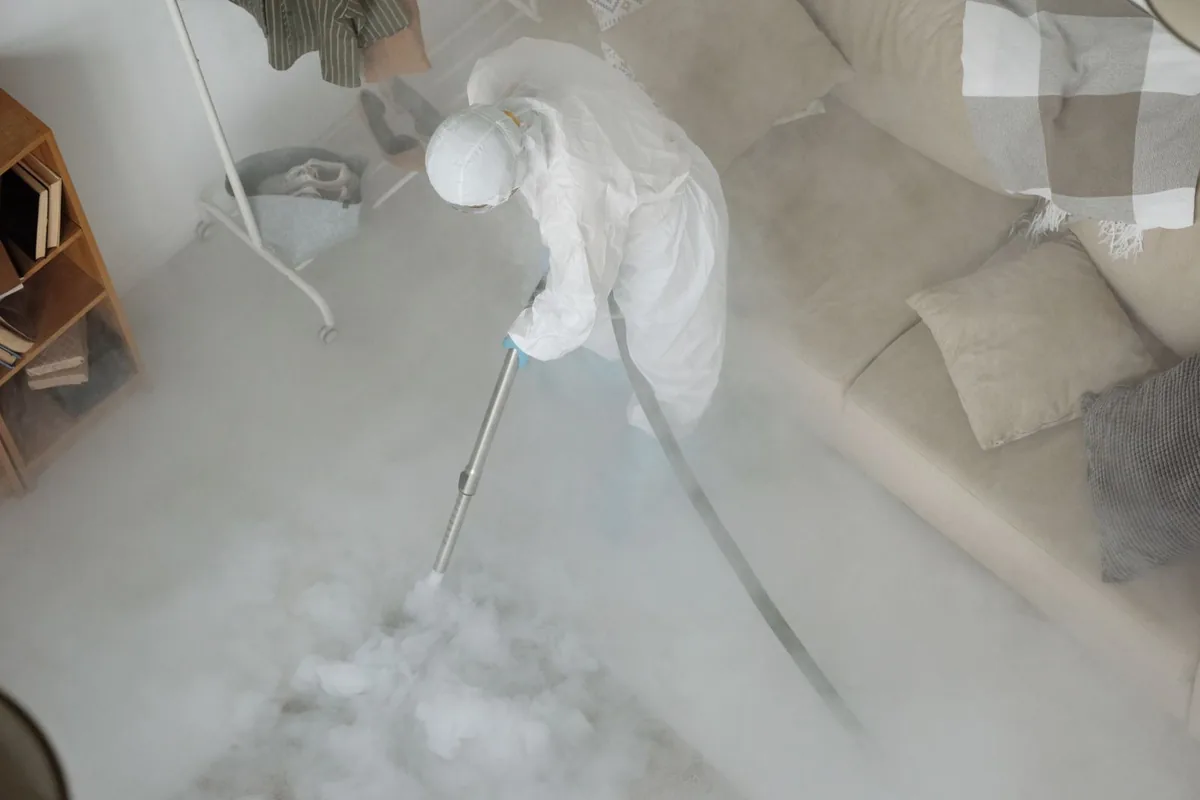 Biohazard cleanup technician in protective equipment, Lake Mills, WI